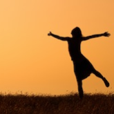 silhouette of girl against orange sky