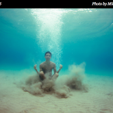 boy underwater in meditation pose