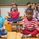 Children sit in meditation