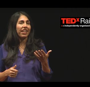 Woman presenting at a TED talk